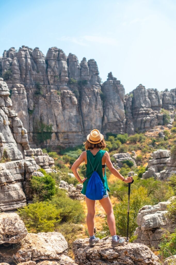 A young woman in Torcal de Antequera on the green and yellow trail enjoying freedom, Malaga